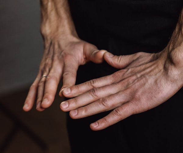 Close-up of a woman's hands in a meditative mudra gesture.